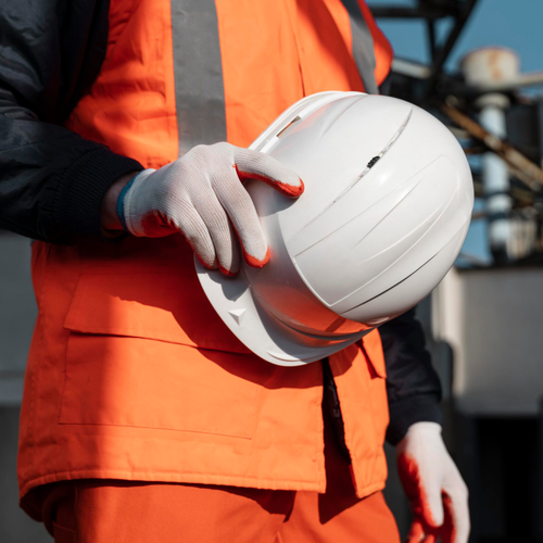 Construction worker holding a safety helmet
